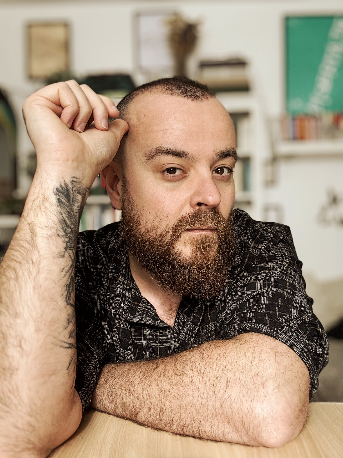 Maurizio Amendola sitting at a table in front of bookshelves